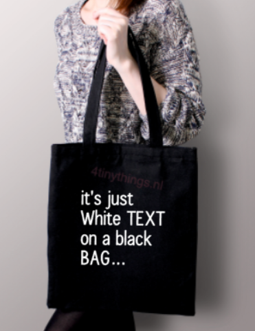 Katoenen tas It's just White text on a black bag